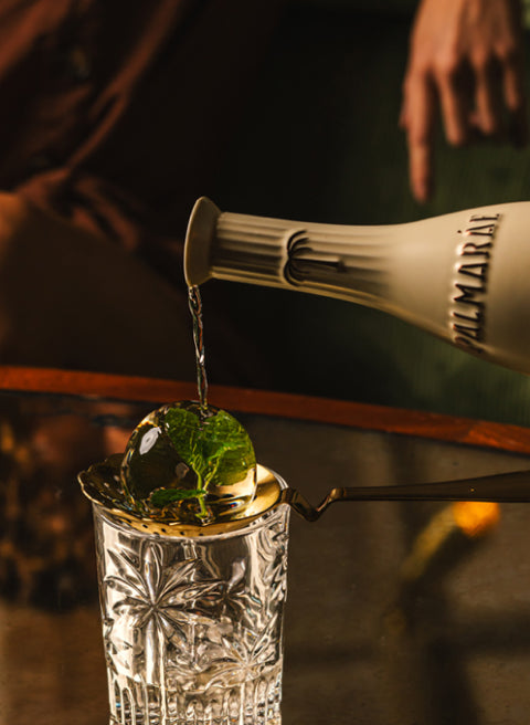 Palmarae gin being poured into a glass.